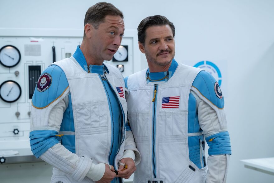 Two members of the Fantastic Four talk together, smiling. They are both wearing space suits.
