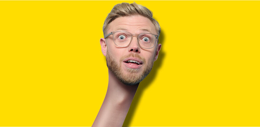 Rob Beckett with a long neck 