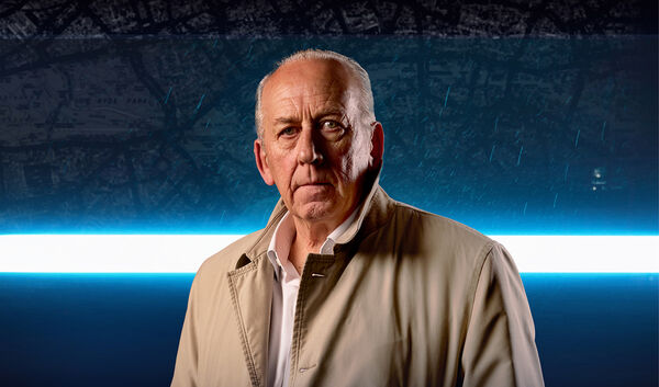 Man in a tan jacket stood in front of a right horizontal light