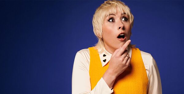 Maisie Adams with her hand under her chin