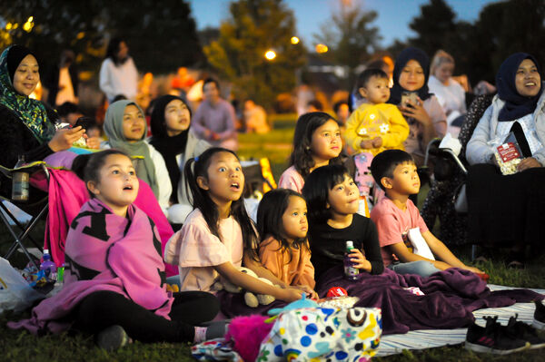 Families gathered to watch an outdoor cinema screening. 