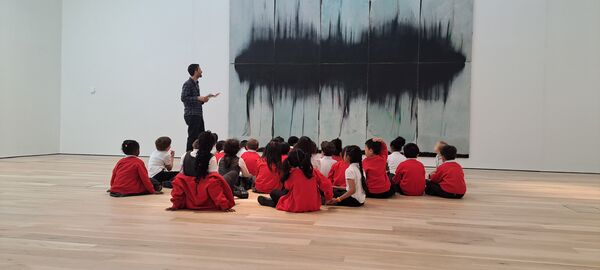 School children sat on the floor of the Mead Gallery looking at a painting