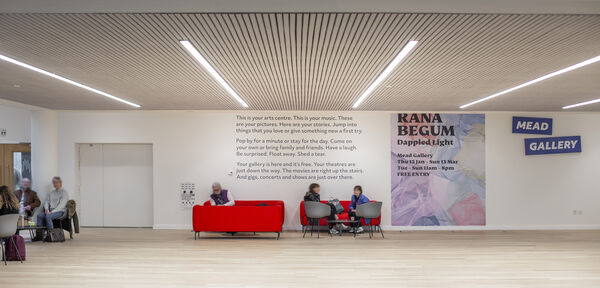 People sat in Gallery Four space on the red sofas